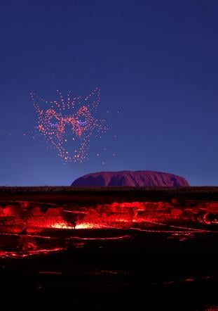 wintjiri wiru kurpany over the outback landscape in front of uluru