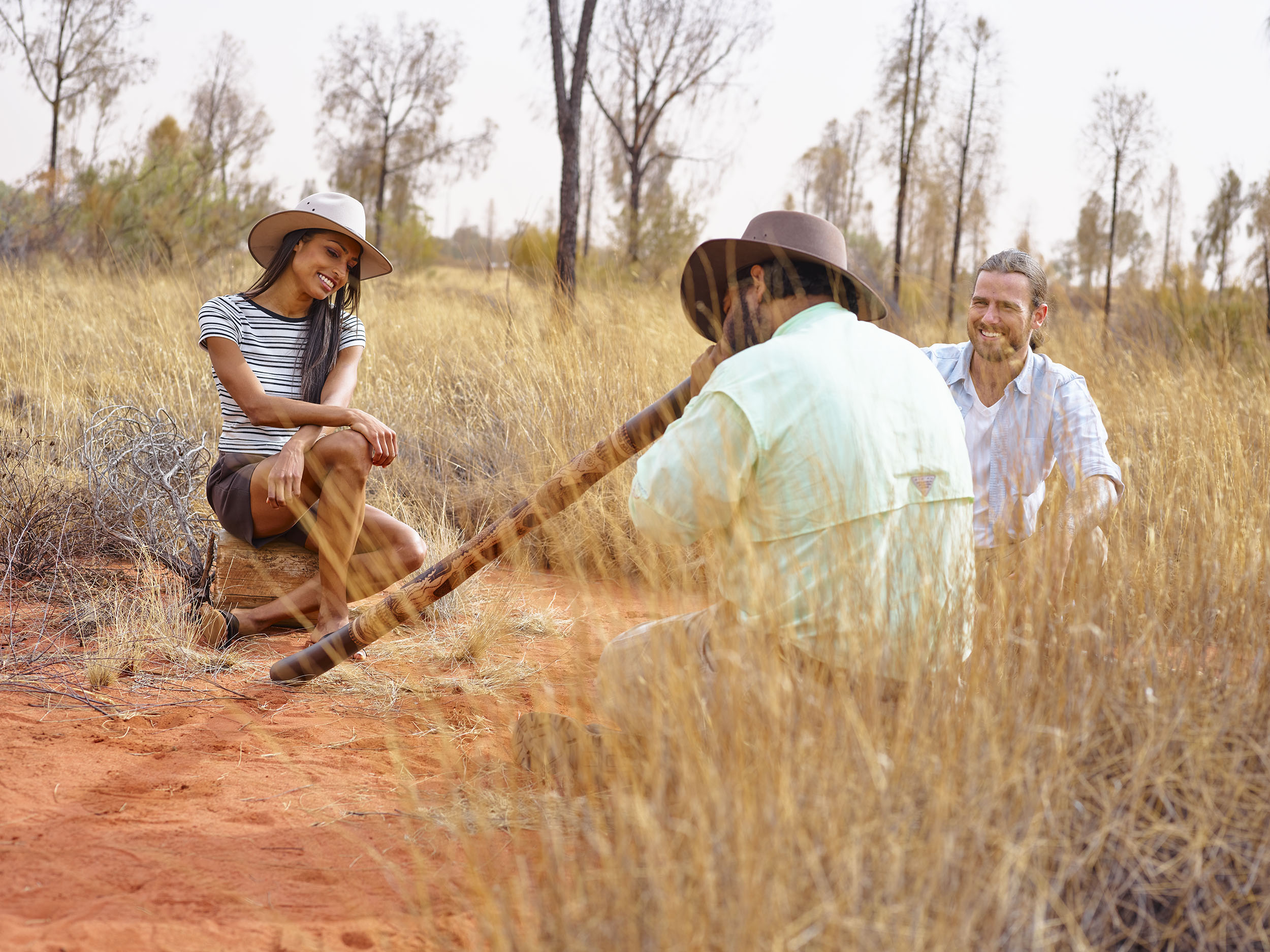 indigenous man playing the didgeridoo