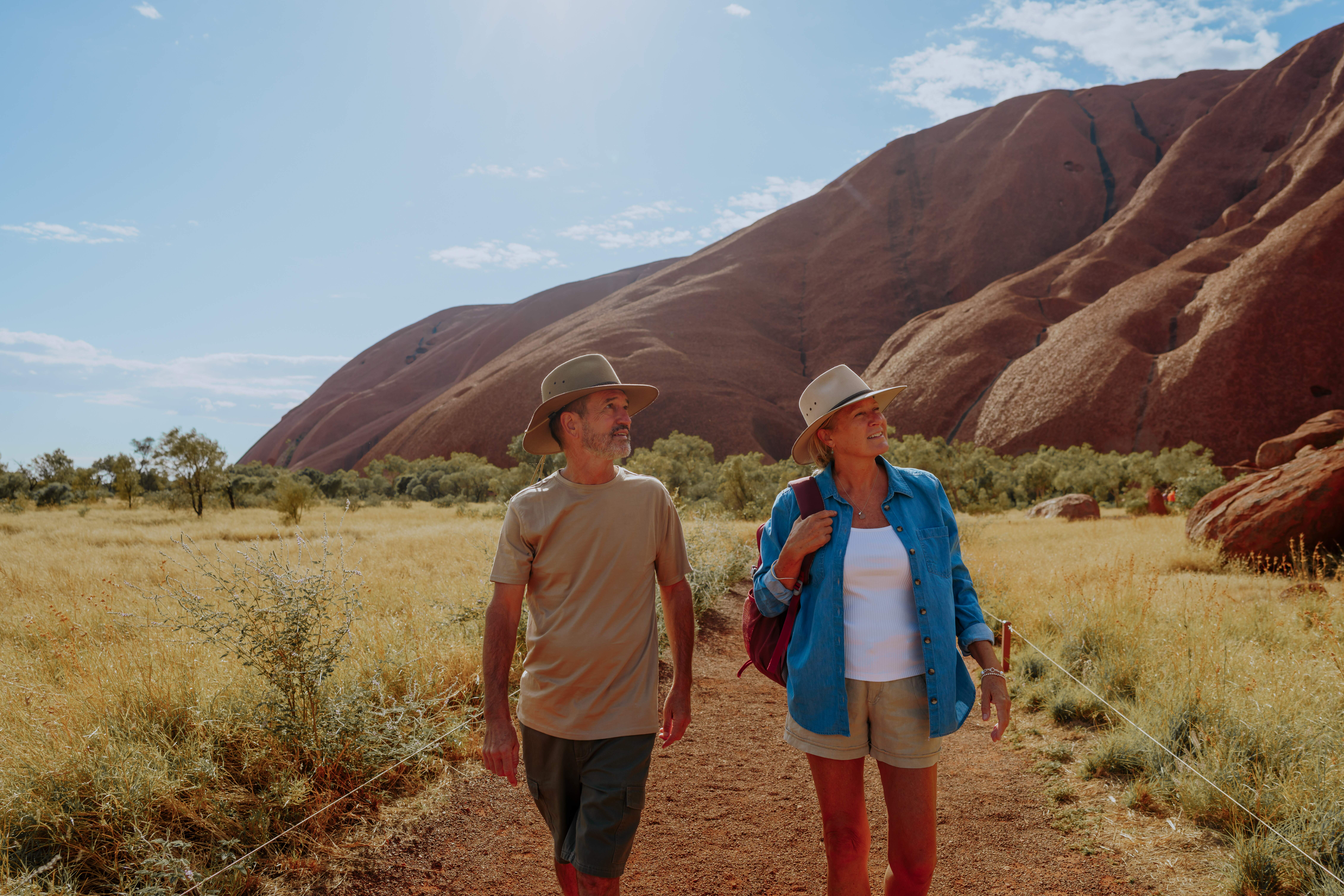 Couple walking around the base of Uluru