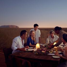 Dining outside with sunset and Uluru