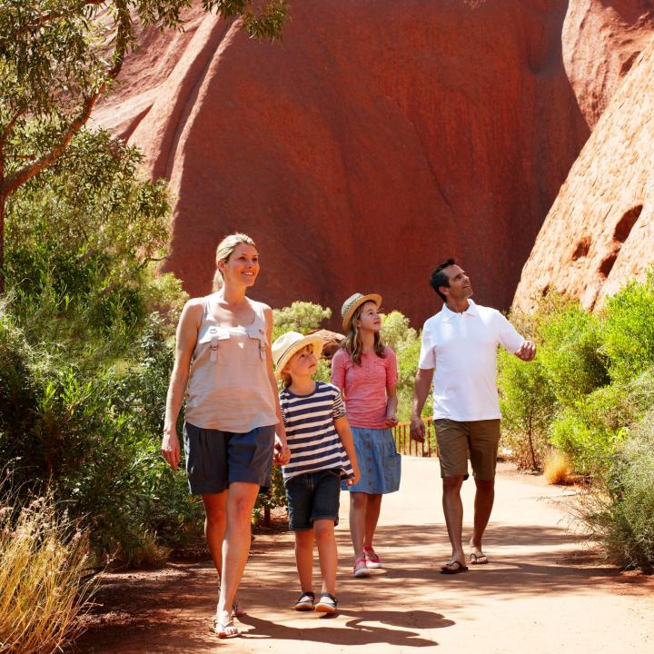 Family with 2 young children on base walk of Ayers Rock Uluru