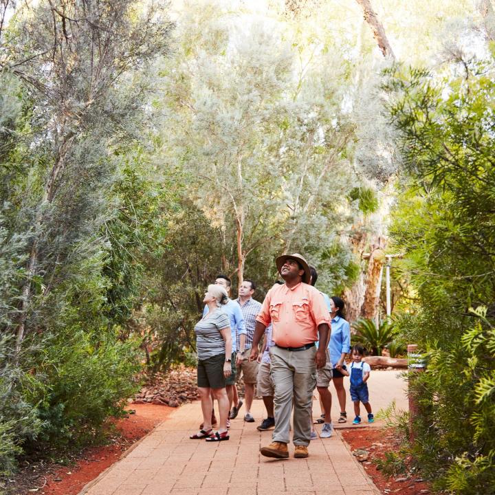 Group taking guided tour of gardens at Ayers Rock Resort