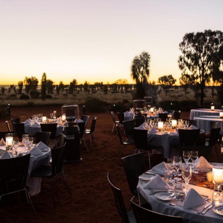 Dining tables set up outdoors at dusk