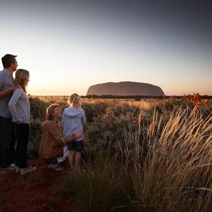 A family looking at Ayer's Rock at sunset | Uluru Australia | Uluru Rockies | Mossmangor Indigenous Tourism