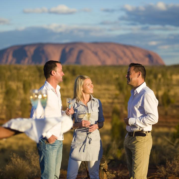 A couple enjoy date night with Uluru in the background