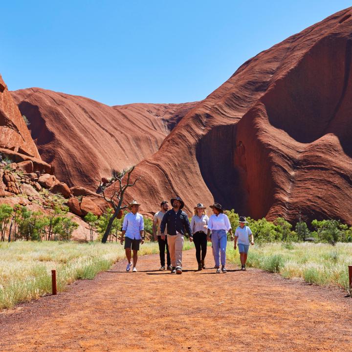 People walking on the Desert Awakenings Tour around Uluru