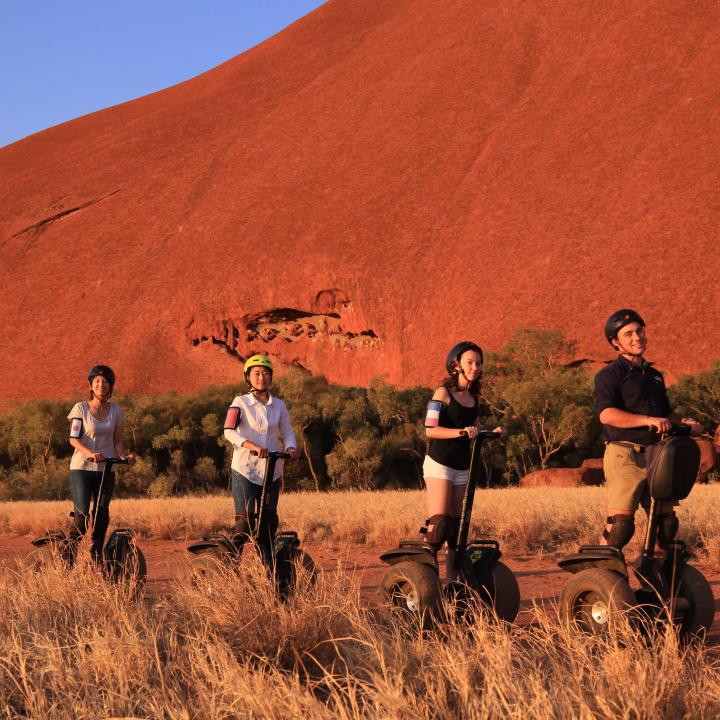 Group of guests on a guided Segway tour at the base of Uluru