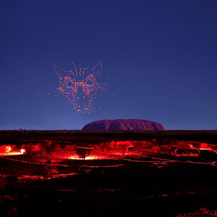 wintjiri wiru kurpany over the outback landscape in front of uluru