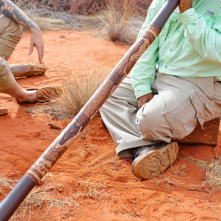 Didgeridoo being played by man in the outback