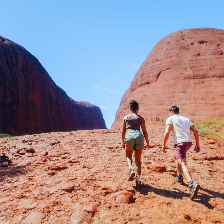 A young couple hiking at Kata Tjuta, in the Northern Territory of Australia