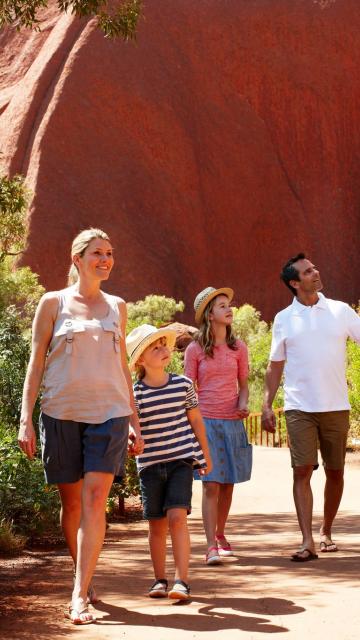 Family with 2 young children on base walk of Ayers Rock Uluru