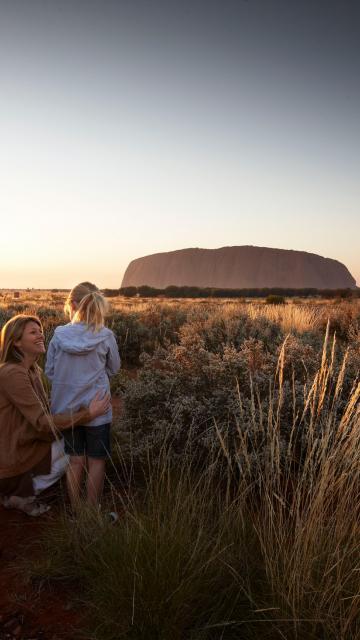 A family looking at Ayer's Rock at sunset | Uluru Australia | Uluru Rockies | Mossmangor Indigenous Tourism