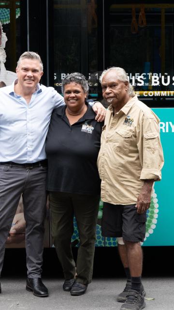 Matt Cameron-Smith - CEO of Voyages Indigenous Tourism Australia, Rachael Hodges - Manager of Mossman Gorge Cultural Centre and Roy Gibson -  Kuku Yalanji Elder, standing in front of Mossman Gorge Brand New Electric Vehicles