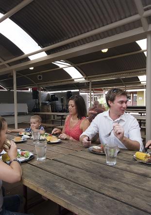 A family enjoys an assortment of food at the Ayers Rock Resort