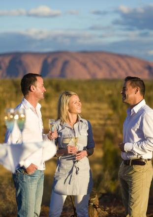 A couple enjoy date night with Uluru in the background