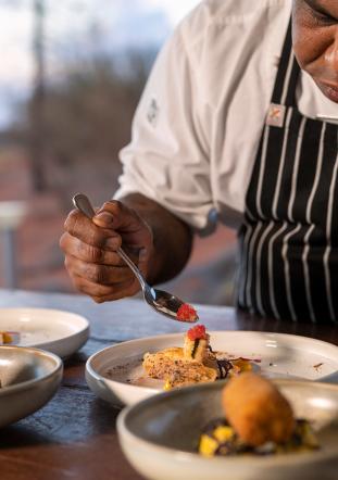 Tali Wiru chef preparing entrees